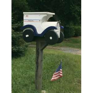 United States Flag and a Mailbox Designed to Look Like a Mail Truck 