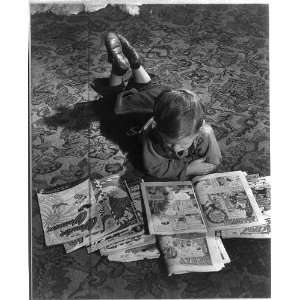  Child lying on floor with comic books,little boy