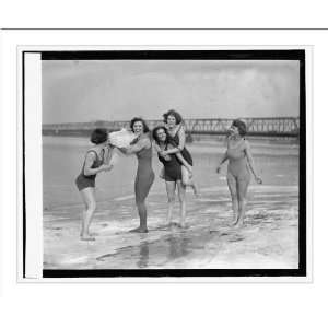   Five women in swimsuits on icy beach], 2/23/24